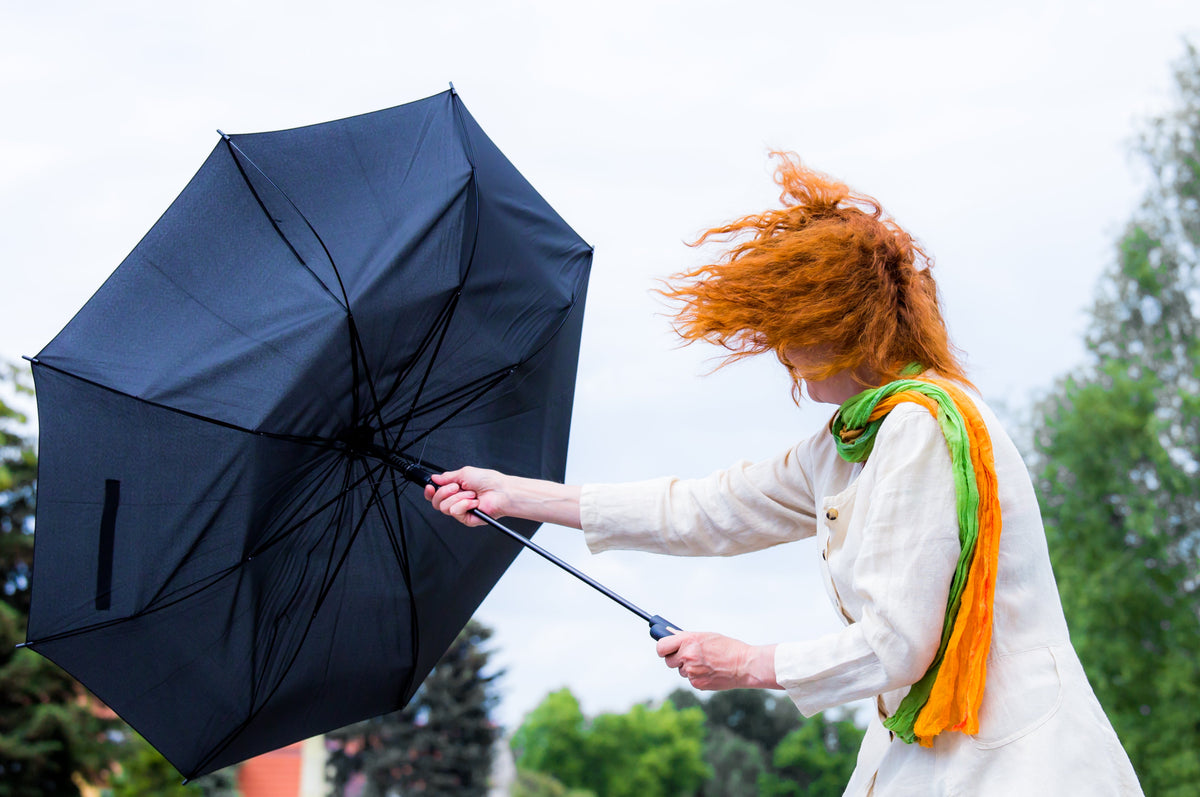 Windy day blowing umbrella inside out