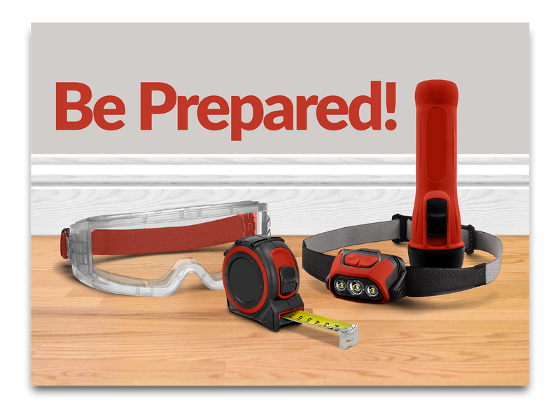 A prepared-casual scene with the words 'Be Prepared!' in large red text above three safety/camping-style items arranged on a wood floor: clear protective goggles with red straps, a red-and-black tape measure, and a red-and-black headlamp with a black strap.