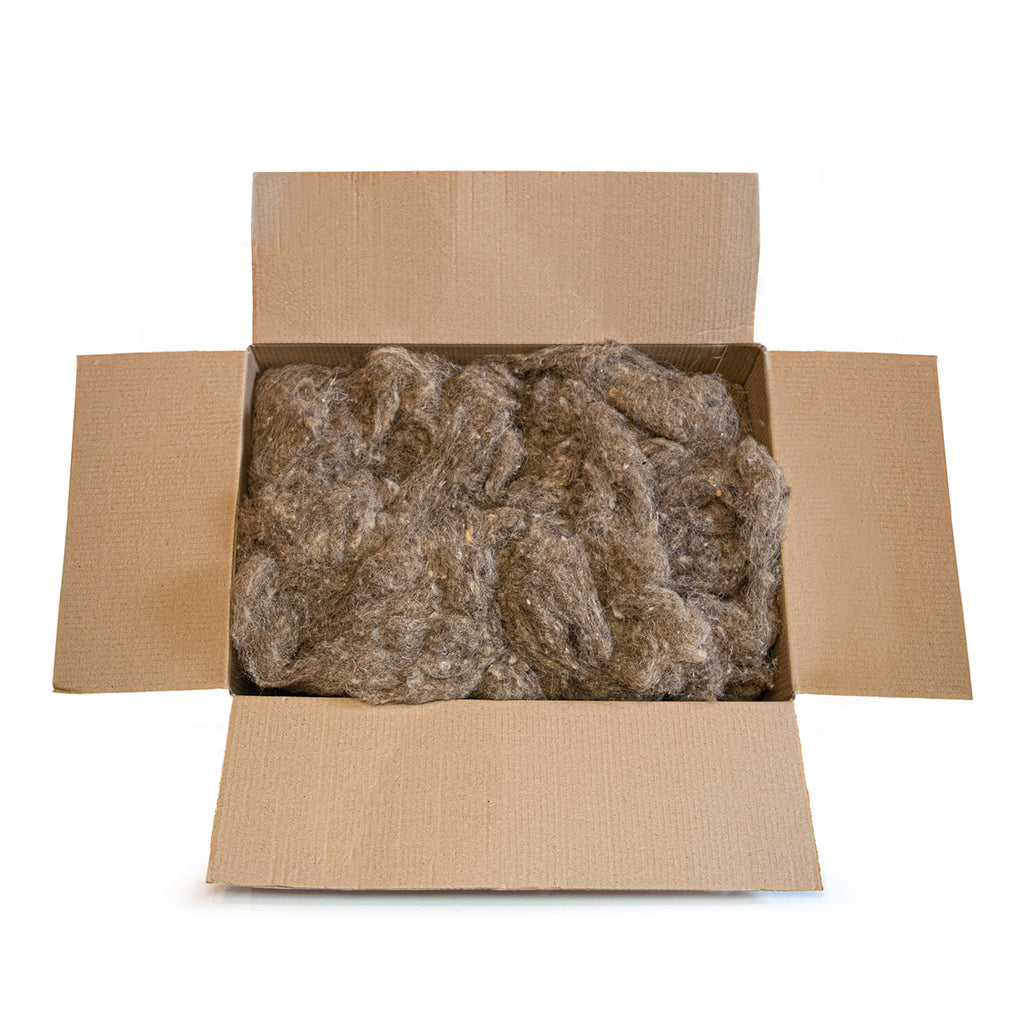 Open brown cardboard box filled with fluffy grey-brown insulation, photographed on a clean white background.