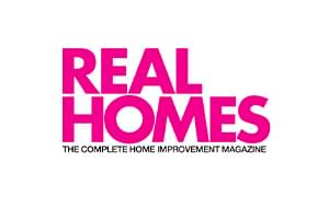 The logo for Real Homes magazine, featuring the words 'REAL HOMES' in bold pink lettering with the subtitle 'THE COMPLETE HOME IMPROVEMENT MAGAZINE' in black below, set against a plain white background.